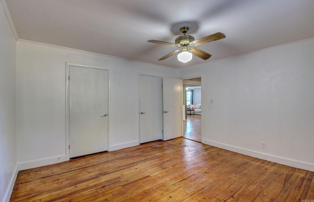 unfurnished bedroom with light hardwood / wood-style flooring, ornamental molding, and ceiling fan