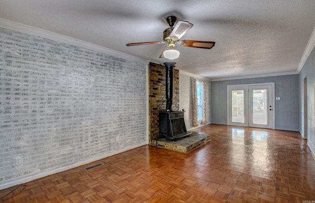 unfurnished living room featuring crown molding, parquet floors, a textured ceiling, and ceiling fan