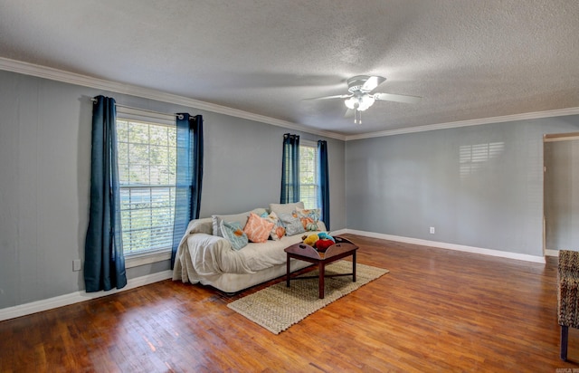 living room with ceiling fan, a healthy amount of sunlight, ornamental molding, and dark hardwood / wood-style floors