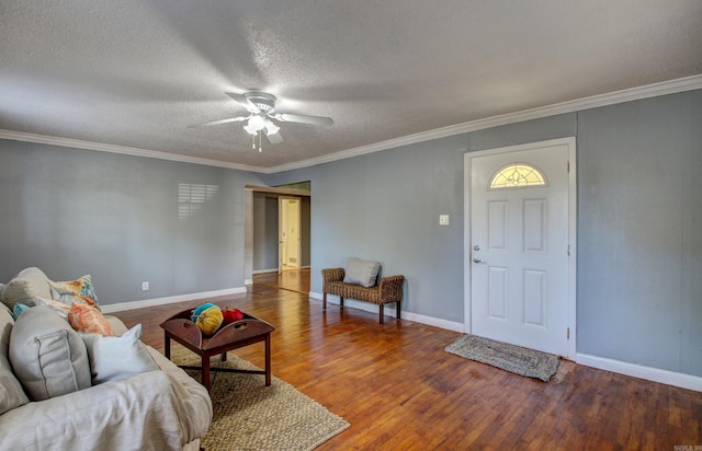 living room with crown molding, hardwood / wood-style floors, a textured ceiling, and ceiling fan