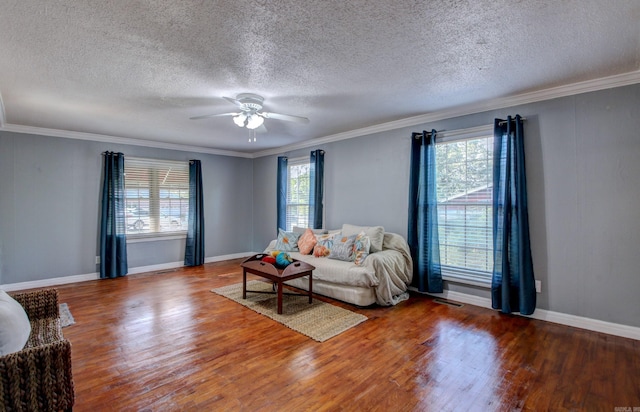 unfurnished living room featuring a textured ceiling, ceiling fan, wood-type flooring, and plenty of natural light