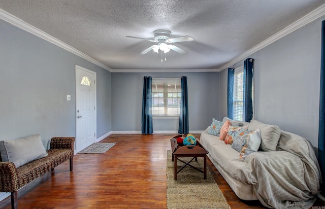 living room featuring ornamental molding, dark hardwood / wood-style floors, and a textured ceiling