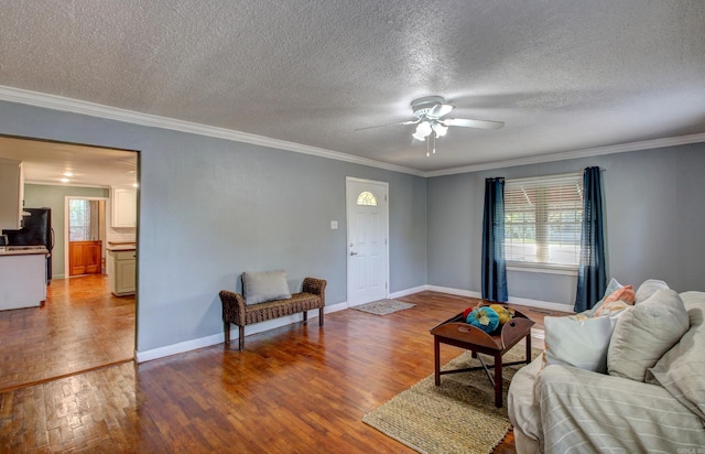 living room with light wood-type flooring, crown molding, a textured ceiling, and plenty of natural light