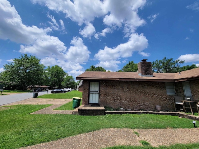 view of property exterior featuring a lawn