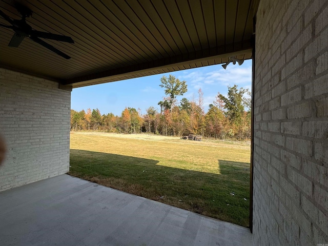 view of yard featuring ceiling fan and a patio area