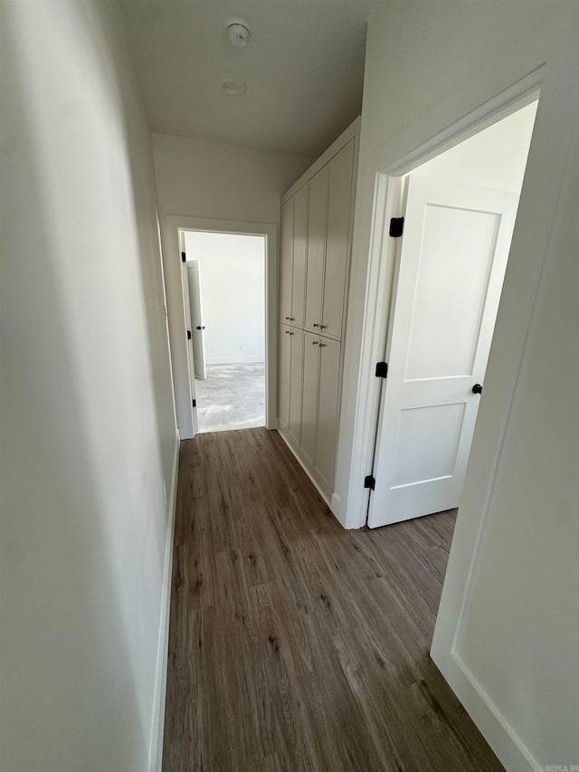 hall with dark hardwood / wood-style floors