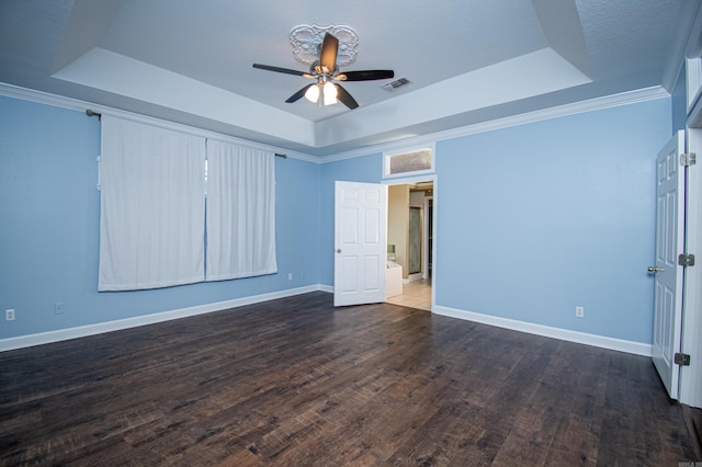 interior space featuring dark wood-type flooring, a tray ceiling, ornamental molding, a textured ceiling, and ceiling fan