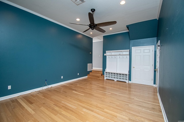 interior space with light hardwood / wood-style floors, ornamental molding, and ceiling fan