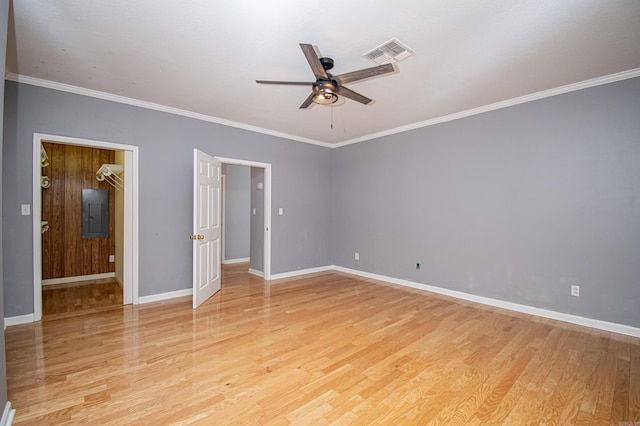 unfurnished bedroom featuring light hardwood / wood-style flooring, ornamental molding, electric panel, and ceiling fan