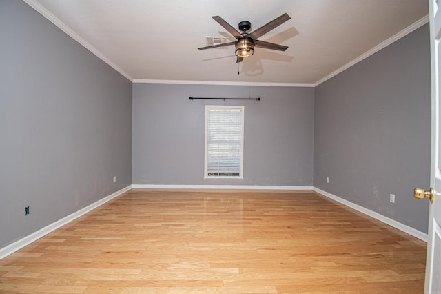 empty room featuring ceiling fan, ornamental molding, and light wood-type flooring