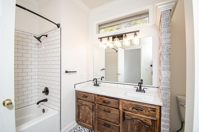 full bathroom featuring tiled shower / bath, vanity, crown molding, and toilet