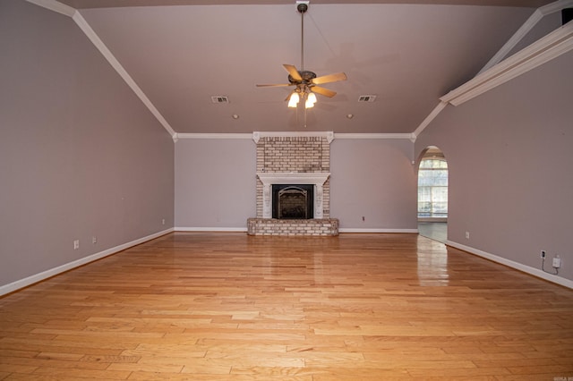 unfurnished living room featuring a fireplace, ceiling fan, lofted ceiling, ornamental molding, and light hardwood / wood-style flooring