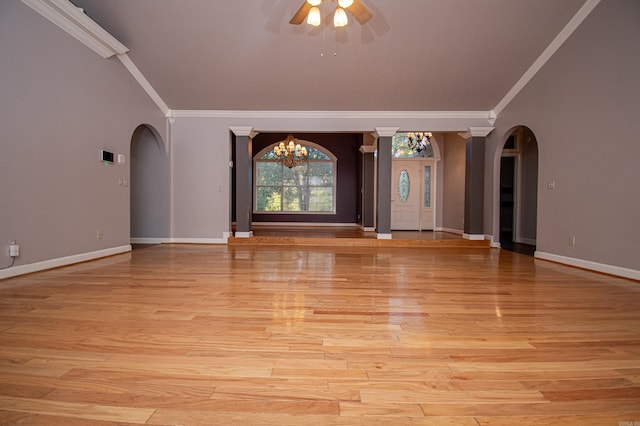 spare room featuring crown molding, ceiling fan with notable chandelier, and light wood-type flooring