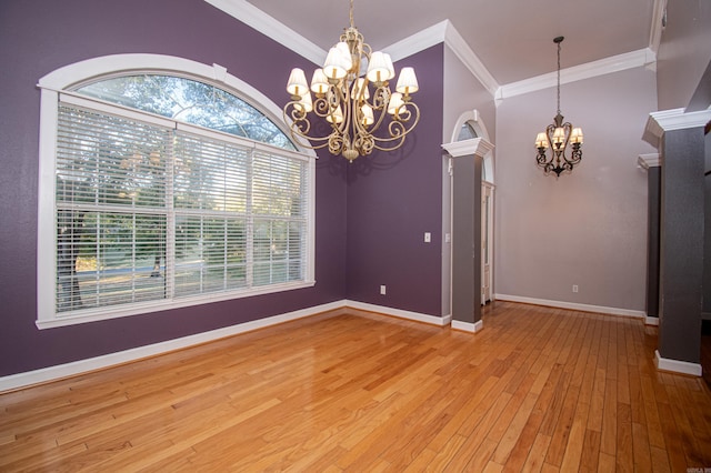 unfurnished dining area featuring a notable chandelier, light hardwood / wood-style floors, and crown molding