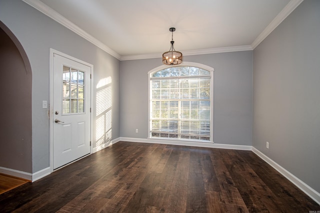 entryway with crown molding, a chandelier, and dark hardwood / wood-style flooring