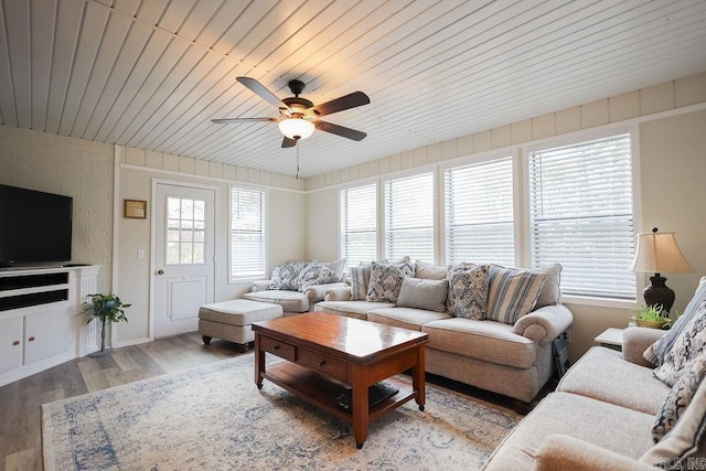 living room with light hardwood / wood-style flooring, wood ceiling, and ceiling fan