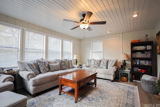 living room featuring wood ceiling, light wood-type flooring, and ceiling fan