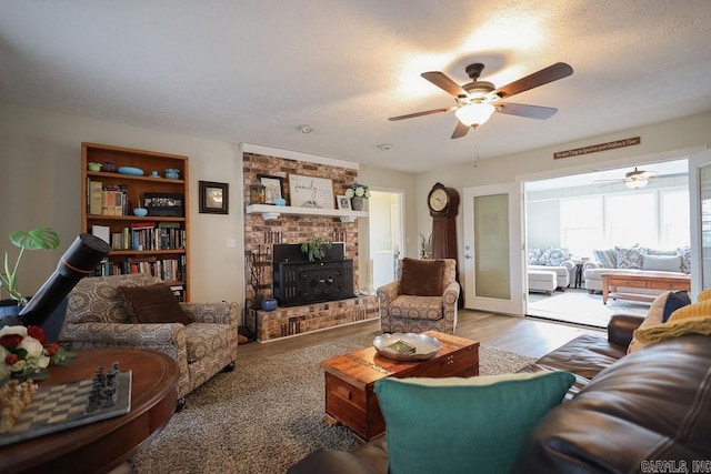 living room featuring hardwood / wood-style floors, a textured ceiling, and ceiling fan