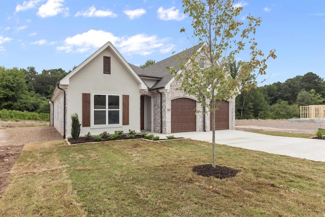 view of front of property with a garage and a front lawn