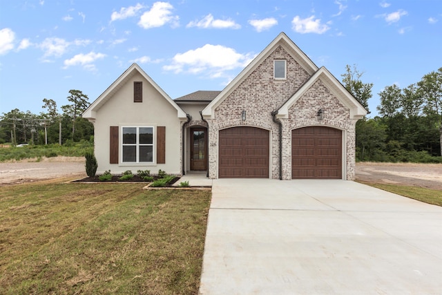 view of front of home featuring a front yard and a garage