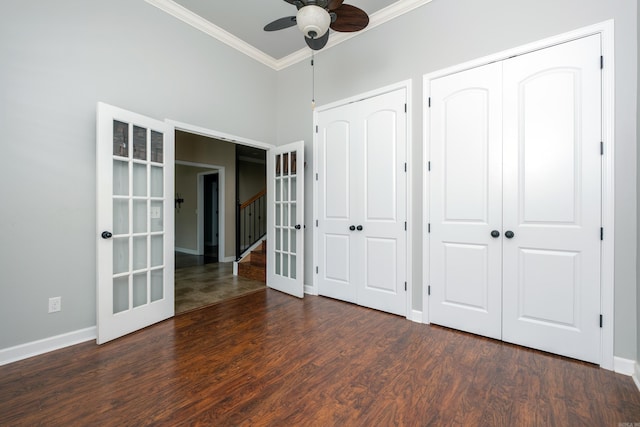 unfurnished bedroom featuring dark hardwood / wood-style flooring, french doors, ornamental molding, and ceiling fan