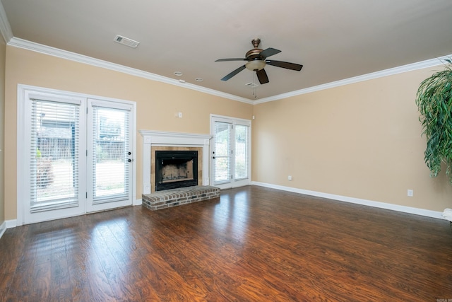 unfurnished living room with a fireplace, french doors, ceiling fan, dark wood-type flooring, and crown molding