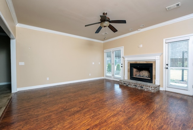 unfurnished living room with ceiling fan, a fireplace, ornamental molding, and dark hardwood / wood-style floors