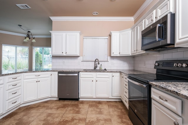 kitchen with ornamental molding, sink, appliances with stainless steel finishes, and white cabinets