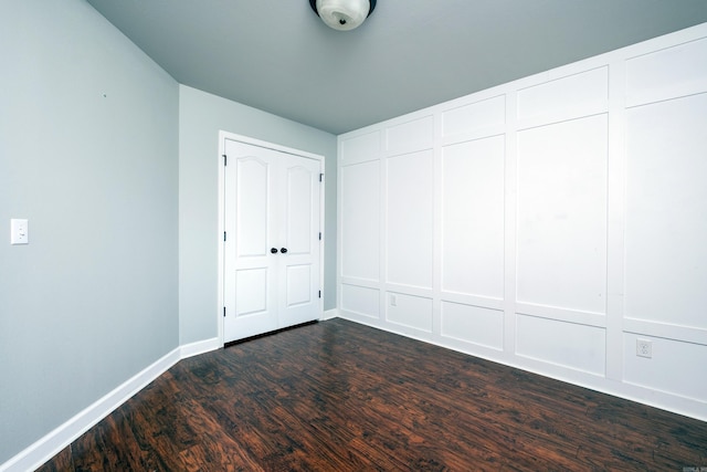 unfurnished bedroom featuring dark hardwood / wood-style floors