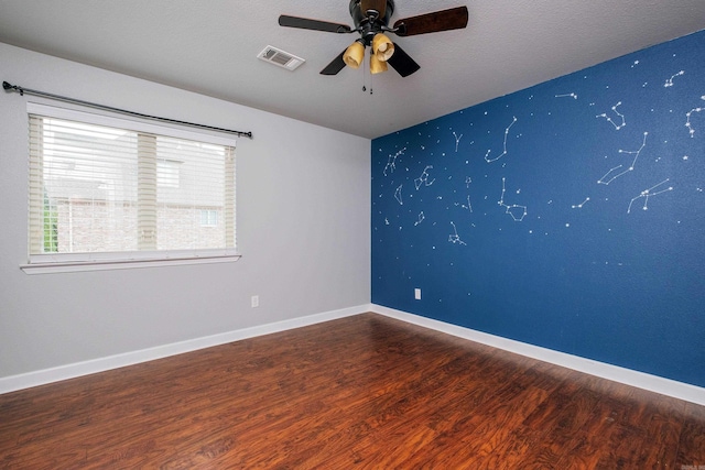 empty room featuring ceiling fan, hardwood / wood-style flooring, and a textured ceiling