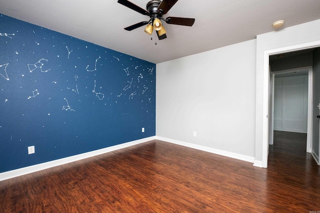 empty room featuring dark hardwood / wood-style floors, a textured ceiling, and ceiling fan