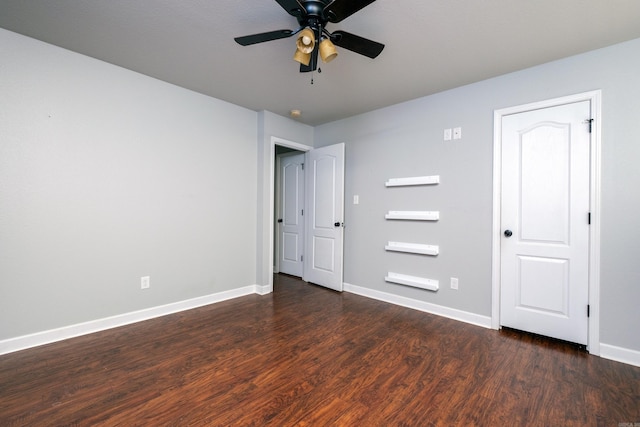 unfurnished bedroom featuring ceiling fan and dark hardwood / wood-style flooring