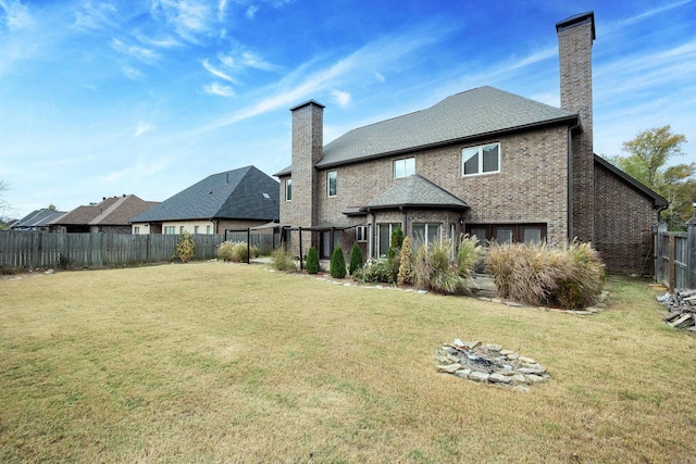 rear view of house with a lawn