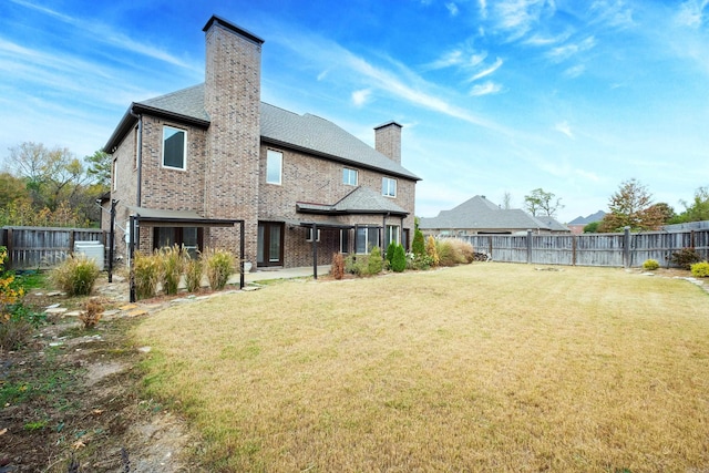 back of house with a yard