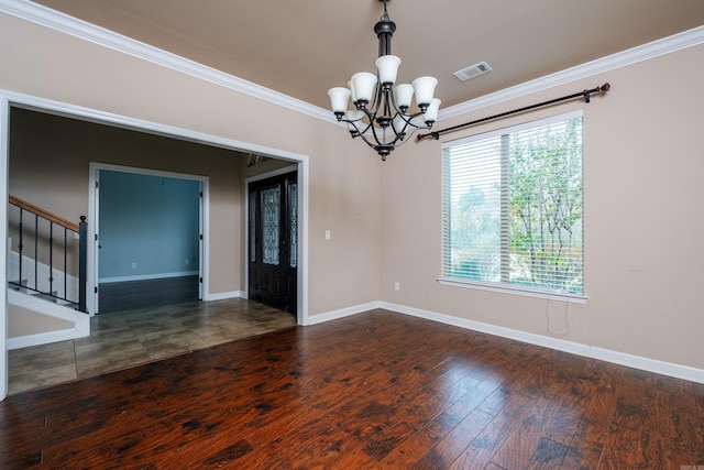 empty room featuring crown molding, an inviting chandelier, and dark hardwood / wood-style floors