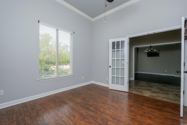 unfurnished room with a wealth of natural light, ornamental molding, and dark wood-type flooring