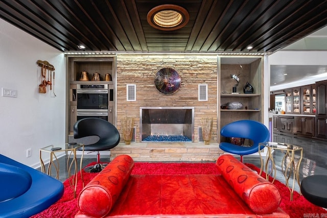 living room with a fireplace and built in shelves