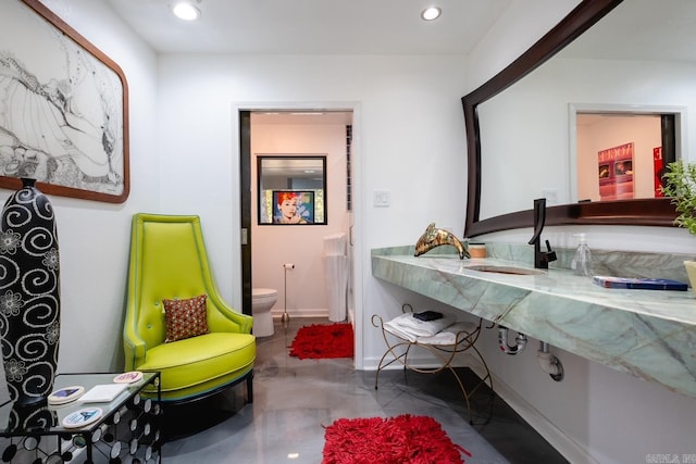 bathroom with toilet and concrete floors