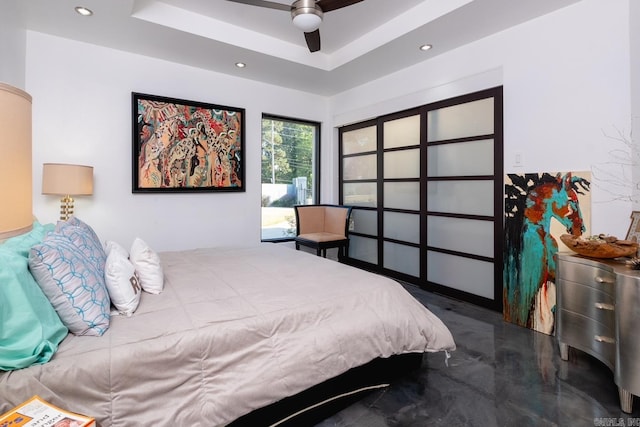 bedroom with a tray ceiling and ceiling fan