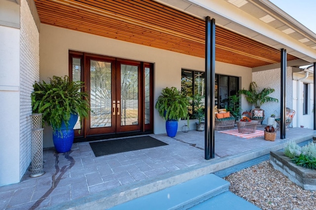 property entrance featuring a patio and french doors