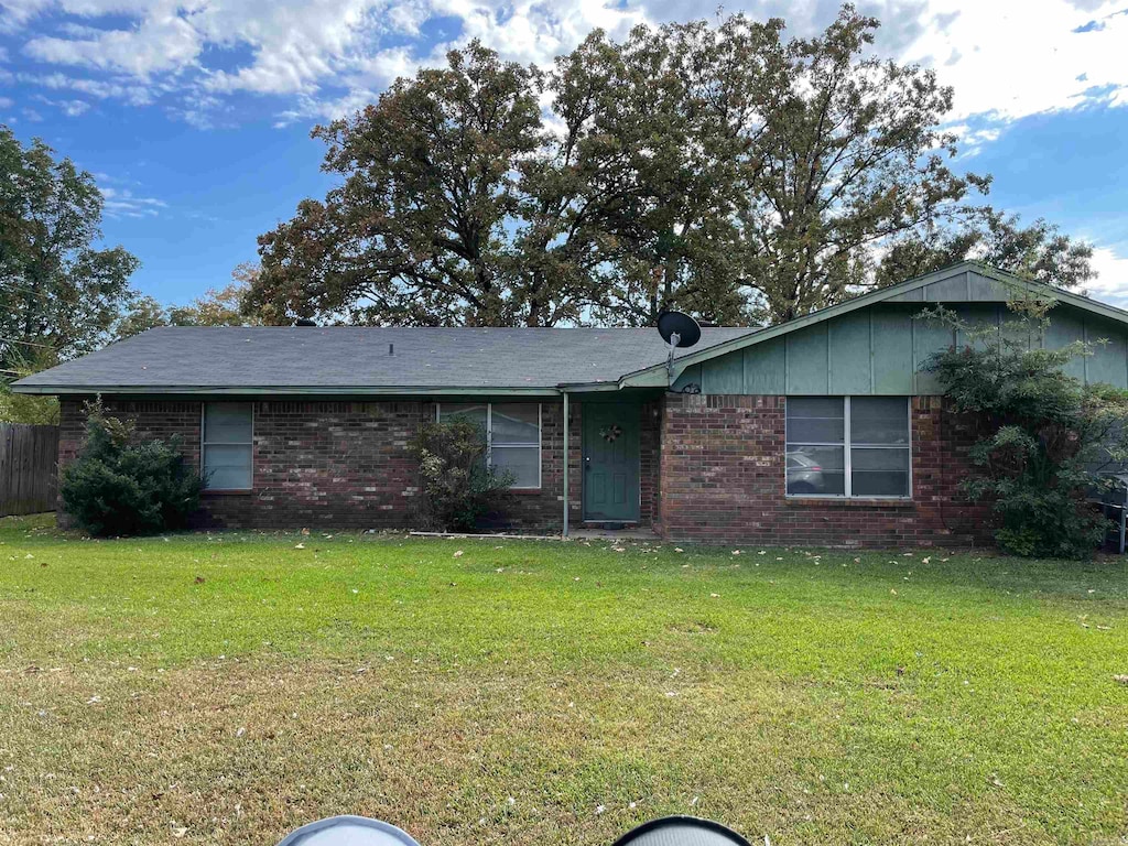 ranch-style house with a front lawn