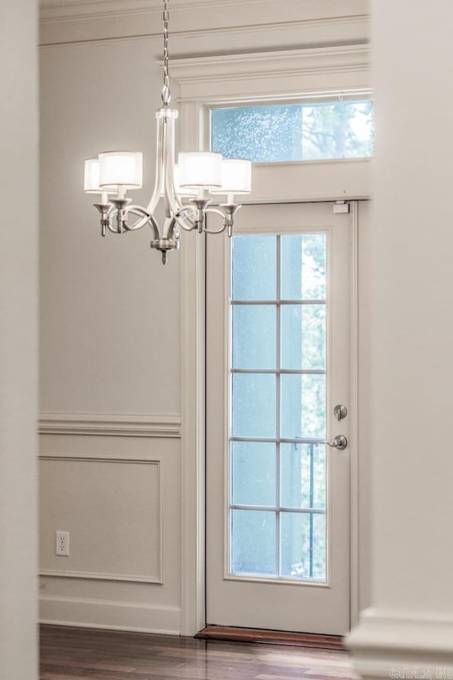 entryway with a chandelier and wood-type flooring