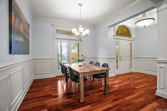 dining space with an inviting chandelier, french doors, ornamental molding, and dark hardwood / wood-style flooring