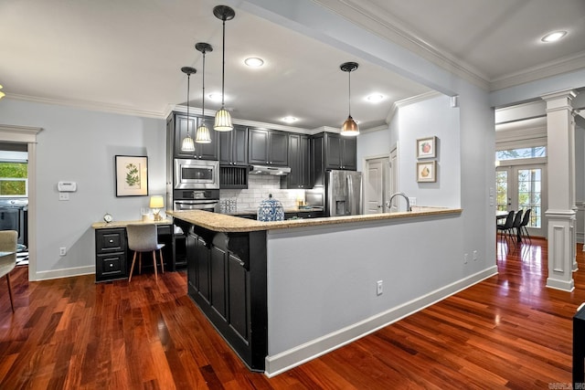 kitchen featuring dark hardwood / wood-style flooring, ornamental molding, stainless steel appliances, and plenty of natural light