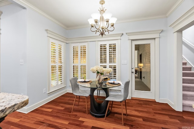 dining area featuring ornamental molding, a chandelier, and dark hardwood / wood-style floors