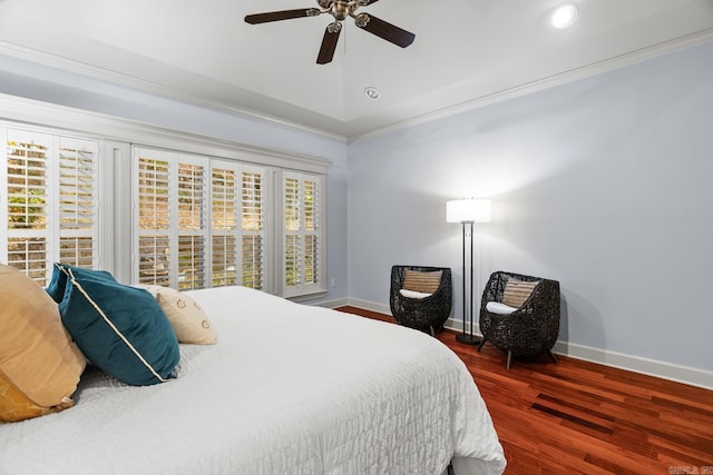 bedroom featuring dark wood-type flooring, ceiling fan, and ornamental molding