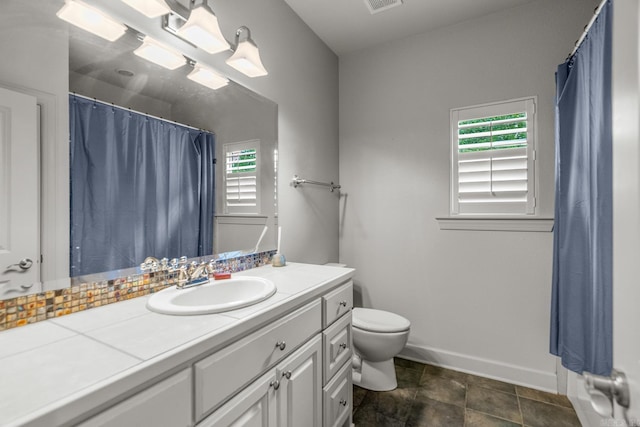 bathroom with toilet and vanity