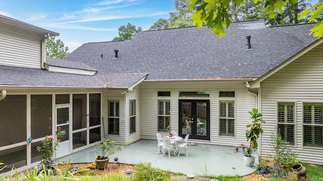 rear view of property with a sunroom and a patio area