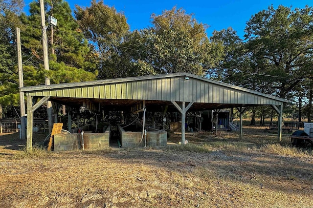 view of community with a carport, an outdoor structure, and an outbuilding