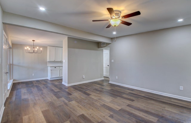 interior space featuring dark hardwood / wood-style flooring and ceiling fan with notable chandelier